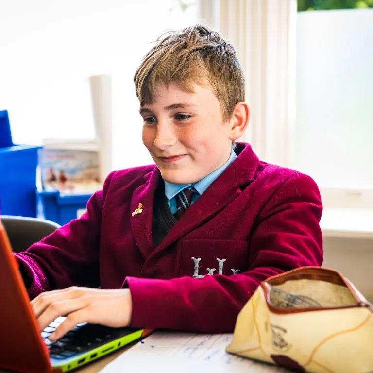 Student on laptop, Holmwood house school