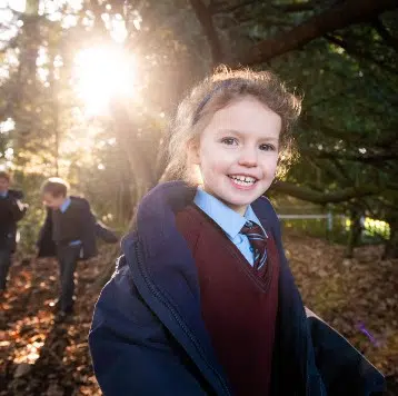 Student playing in the woods