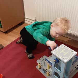 student playing with a car park playset