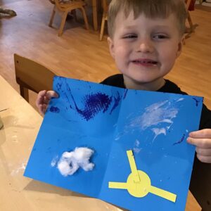 boy with paper and his crafts