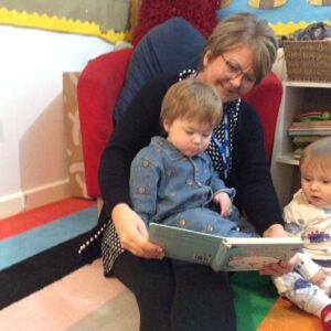 teacher reading to two children