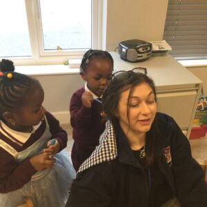 students playing with a person's hair