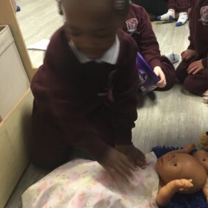 students playing with dolls