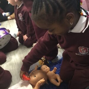 students playing with dolls