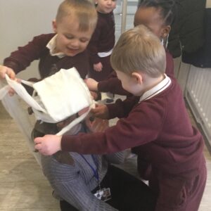 children dressing up a teacher