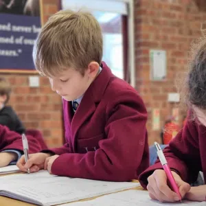 students writing out onto booklets